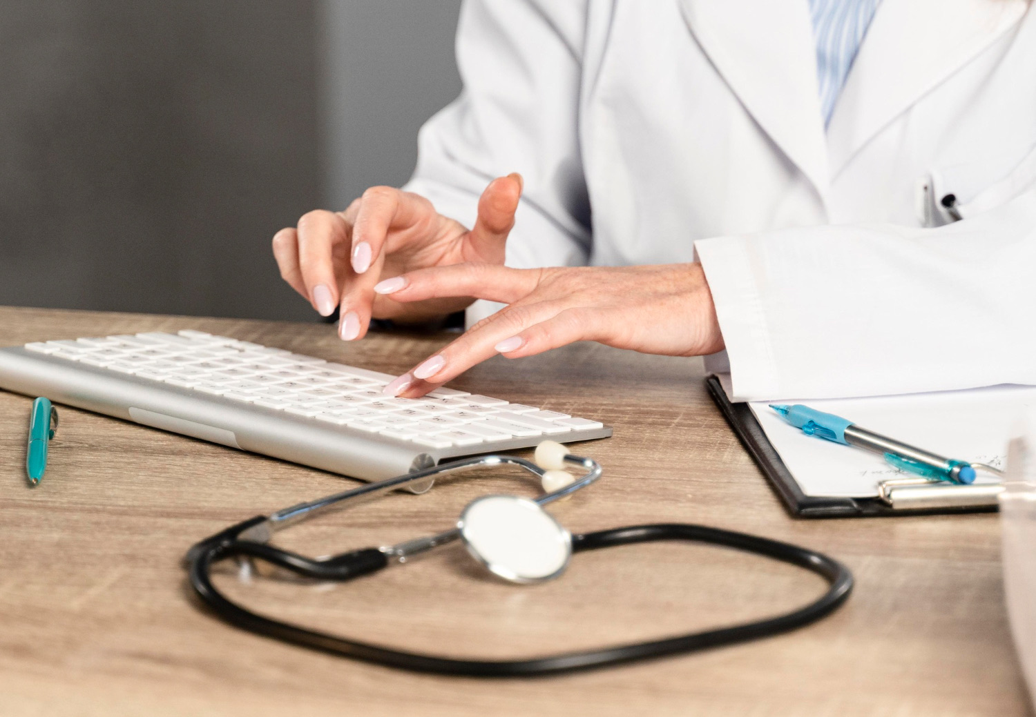 Doctor typing clinical notes for The Prep Rooms GP pathway